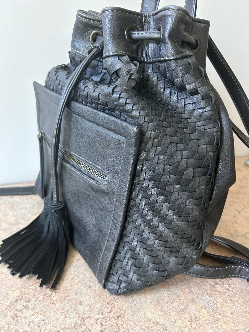 Moda Luxe Black Leather Woven Backpack With Drawstring and Tassles